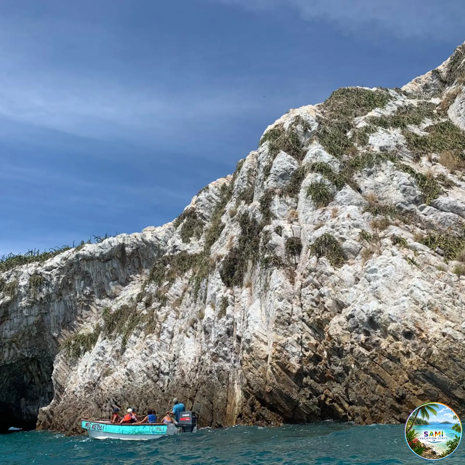 Boat tour along rocky sea cliffs