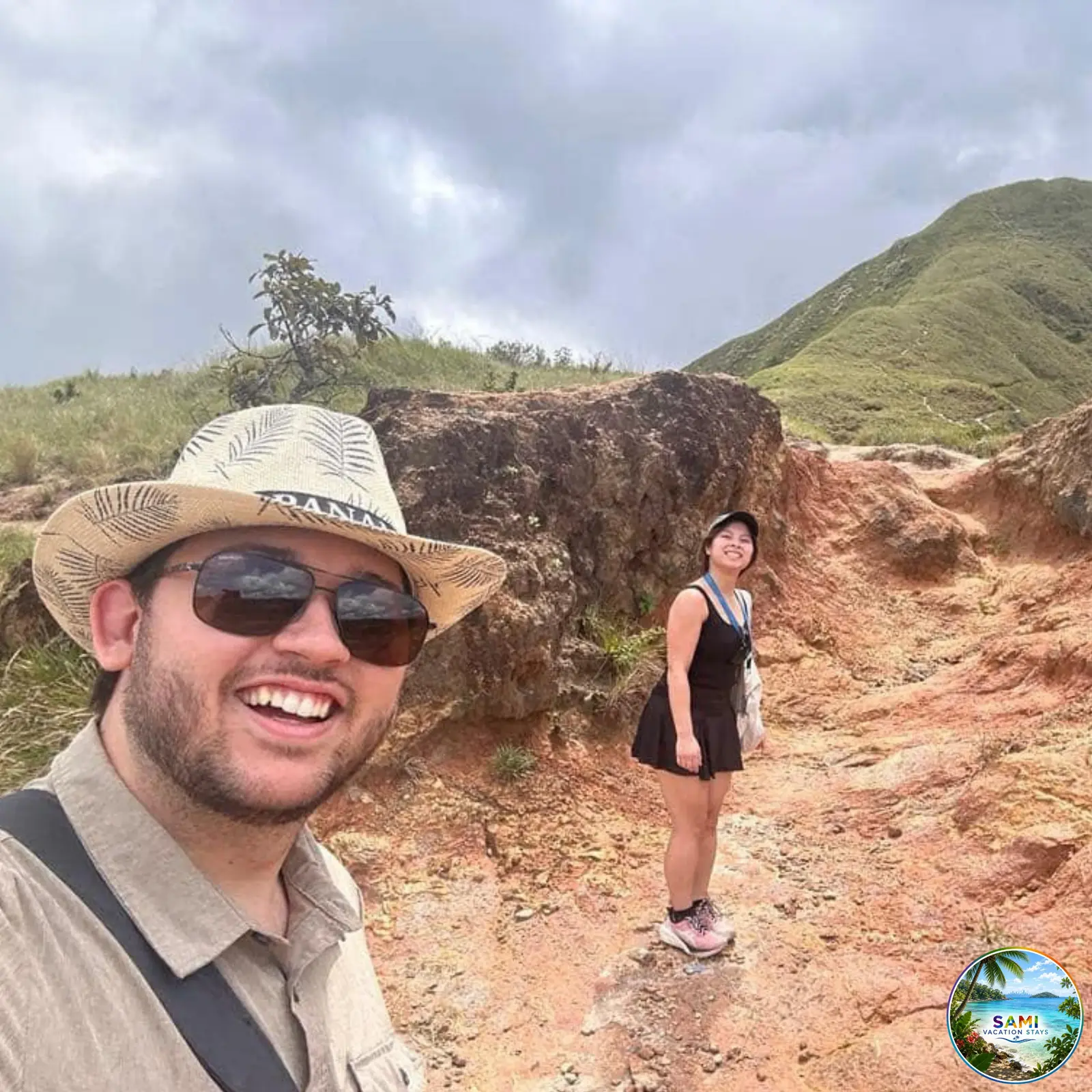 Hikers posing on a rocky mountain trail