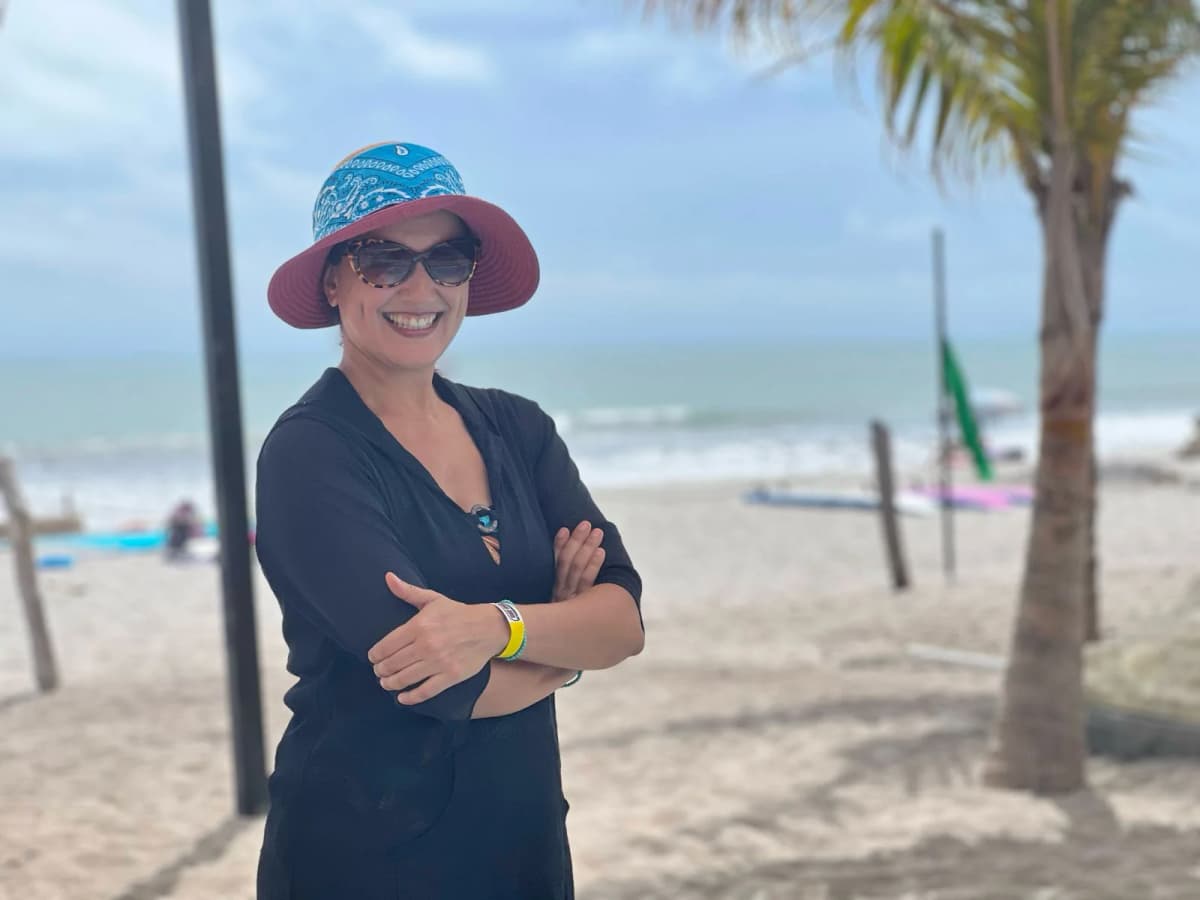 Sami at the beach in a sun hat