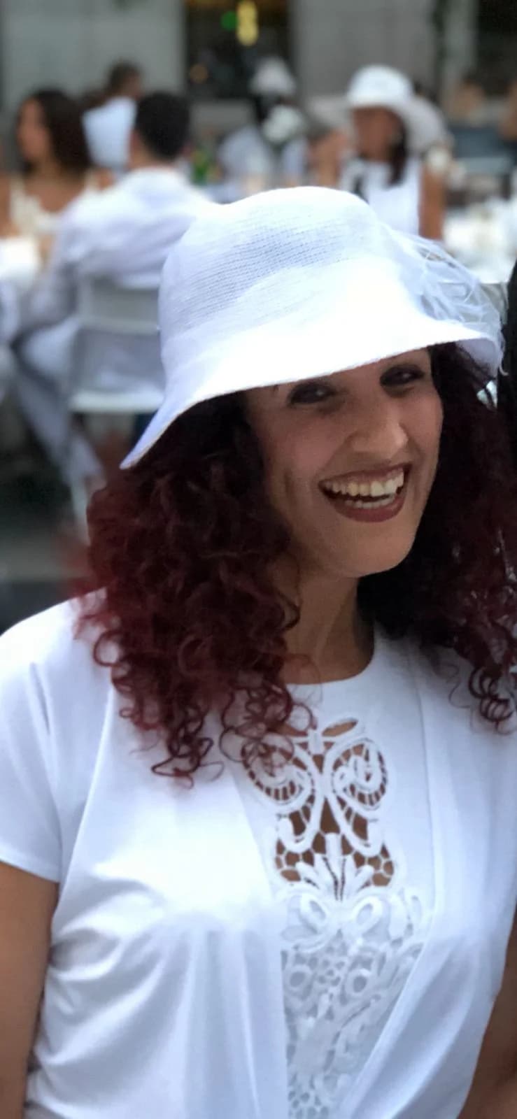 Sami in a white hat and outfit